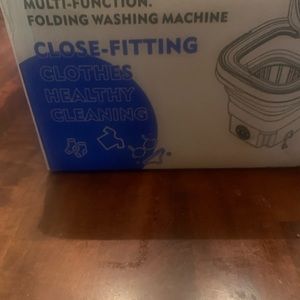Miniature purple washing machine.